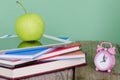 Back to school! Pile of books and digital tablet, green apple an Royalty Free Stock Photo