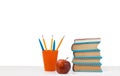 Back to school, pile of books and red apple on the white table with white background. Distance home education. Quarantine concept Royalty Free Stock Photo