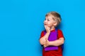 Back to school Portrait of happy surprised kid in glasses isolated on blue background with copy space. new school knowledges Royalty Free Stock Photo