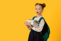 Back To School. Portrait Of Surprised Nerdy Schoolgirl Carrying Heavy Books Royalty Free Stock Photo