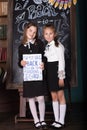 Back to school. Portrait of two girls, first graders.