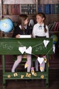 Back to school. Portrait of two girls, first graders.