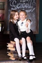 Back to school. Portrait of two girls, first graders.