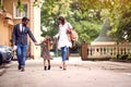 Back to school. pupil girl with backpack with her parents and going to school