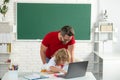 Back to school. School pupil with teacher learning at laptop computer, studying with online education e-learning in Royalty Free Stock Photo