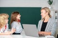 Back to school. School pupil with teacher learning at laptop computer, studying with online education e-learning in Royalty Free Stock Photo