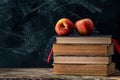 Back to school, Red Apple fruits on top of Book on Stack of Books with chalk board Royalty Free Stock Photo