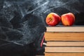 Back to school, Apple fruits on top of Book on Stack of Books with chalk board as background Royalty Free Stock Photo