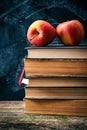 Back to school, Red Apple fruits on top of Book on Stack of Books with chalk board Royalty Free Stock Photo