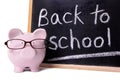 Back to school reminder, piggybank, blackboard, education costs concept Royalty Free Stock Photo