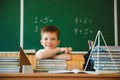 Back to school. A schoolboy is reading a book while sitting at the table for the first time at school on the background of the Royalty Free Stock Photo