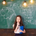 Back to school. Schoolgirl. School concept. Smiling little girl, writting text on blackboard. Little first graders. Back Royalty Free Stock Photo