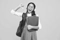 Back to school. Schoolgirl student in headphones with school bag backpack hold book on isolated studio background Royalty Free Stock Photo