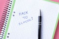 Back to school setup in pink and green colors with notebook and pen Royalty Free Stock Photo