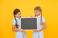 Back to school. small girls hold blackboard. children education. small girls presenting project. old school. copy space Royalty Free Stock Photo