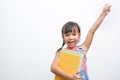Back to school. Smiling little girl carrying a backpack holding books looking at the camera with arms raised on a white background Royalty Free Stock Photo
