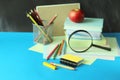 Back to school, stack of books, magnifying glass and stationery