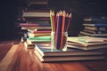 Back to school, stack of books with pencils on the table