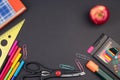 Back to school. Stationery on a black table. Office desk with copy space. Flat lay Royalty Free Stock Photo