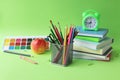 Back to school, stationery, books, alarm clock on bright background Royalty Free Stock Photo