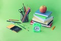 Back to school, stationery, books, alarm clock on bright background Royalty Free Stock Photo