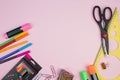 Back to school. Stationery on a pink table. Office desk with copy space. Flat lay