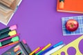 Back to school. Stationery on a Purple table. Office desk with copy space. Flat lay Royalty Free Stock Photo