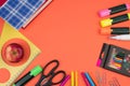 Back to school. Stationery on a salmon-orange color. color table. Office desk with copy space. Flat lay