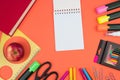 Back to school. Stationery on a salmon-orange color. color table. Office desk with copy space. Flat lay
