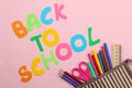 Back to school. stationery, school supplies, text and pencil case with pencils on a bright pink background. top view Royalty Free Stock Photo