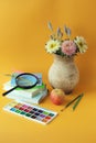 Back to school, stationery, stack of books, vase of flowers, paints on bright background Royalty Free Stock Photo