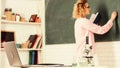 Back to school. student girl writing answer at blackboard. beaker and microscope. student doesnt use laptop. biology Royalty Free Stock Photo