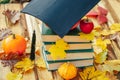 Back to school.Student hat on pumpkin and stack of books on wooden background .Study and education concept.Start school Royalty Free Stock Photo