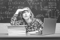 Back to school. Student working on a laptop on some stairs on campus preparing for an exam. Angry screaming - negative Royalty Free Stock Photo