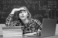 Back to school. Student working on a laptop on some stairs on campus preparing for an exam. Angry screaming - negative Royalty Free Stock Photo