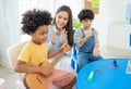 Back to school and summer course. children play guitar in kindergarten