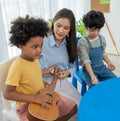 Back to school and summer course. Little children play guitar in kindergarten class