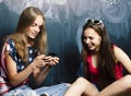 Back to school after summer vacations, two teen girls in classroom with blackboard painted together Royalty Free Stock Photo