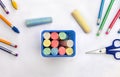 Back to School. School supplies  blue box with crayons, pencil, eraser, scissors  on a white background. Top view, flat lay Royalty Free Stock Photo