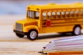 Back to school supplies colored pencils toy yellow school bus on wooden background Royalty Free Stock Photo