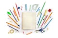 Back to School. School supplies copybook, pencils, sharpener, clips, compass, protractor, scotch tape, scissors on a white