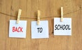 Back to school and support symbol. Concept words Back to school on white papers on wooden clothespins. Beautiful wooden background