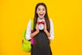 Back to school. Teenager school girl with backpack hold clock alarm, time to learn. School children on isolated yellow