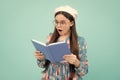 Back to school. Teenager schoolgirl with book ready to learn. School girl children on isolated blue studio background