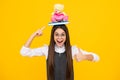 Back to school. Teenager schoolgirl hold book with toy ready to learn. School children on isolated yellow studio Royalty Free Stock Photo