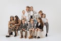 Ten happy smiling kids, little girls and boys in modern outfits posing on grey studio background. Beauty, kids fashion Royalty Free Stock Photo