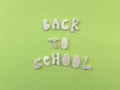 Back to school text composed with wooden letters over green color