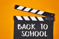 Back to School Text on a Film Slate Board with Orange Background Royalty Free Stock Photo