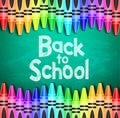 Back to School Text on Green Chalkboard Background with Different Colored Crayons Royalty Free Stock Photo