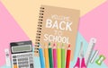 Back to school text on notebook with school supplies on pastel color background